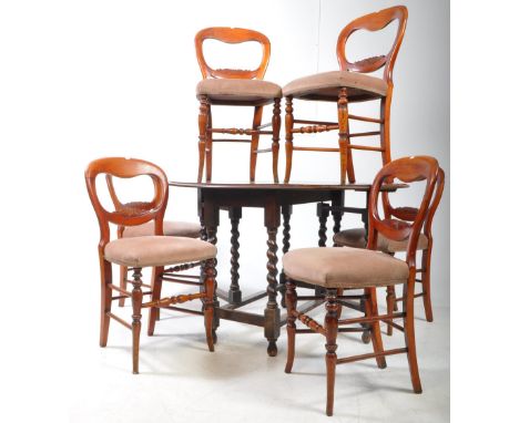 A 19th century oak wood barley twist drop leaf dining table and six Victorian baloon back dining chairs. The table top of rou