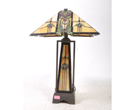 A large vintage 20th century Tiffany style coloured leaded glass table lamp. The lamp of angulatr form, featuring pyramid sty