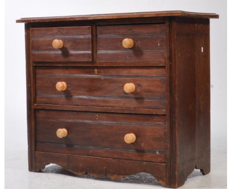 An Edwardian mahogany Arts &amp; Crafts walnut cottage chest of drawers. Raised on bracket feet with short and deep drawer co
