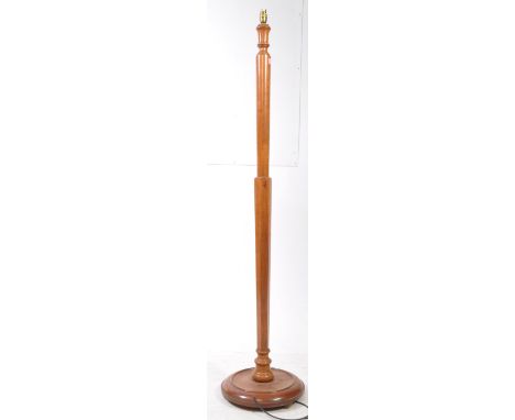 An early 20th century 1930s walnut floor standard lamp. The lamp with terraced base having tapering column with electrics ato