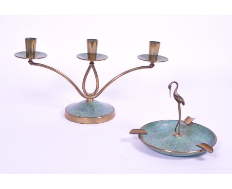 A 1950s Japanese brass candlestick candelabra together with a matching ashtray stand adorned with a central crane / stork des