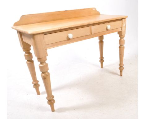 A 19th century Victorian pine wood writing console table. The table raised on turned legs, with a pair of drawers to front. E