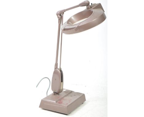 RS - A vintage 20th century industrial tabletop illuminated bench magnifier lamp. The lamp in a metallic pink grey colourway.