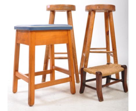 A pair of early 20th century beech and elm wood bar stools. Each stool with thick elm tops on tapering supports with leg stre