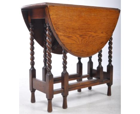 A 19th century oak barley twist drop leaf gate leg table. Raised on turned barley twist supports. Having a rounded drop leaf 