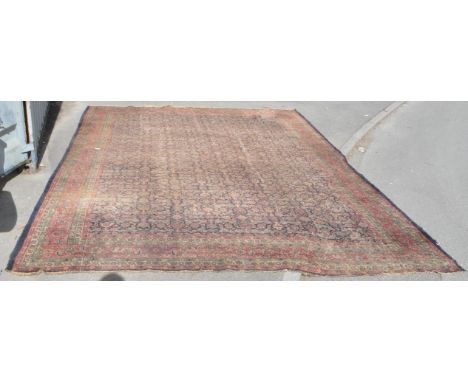 Large early 20th century Persian Islamic carpet floor rug. With floral motifs encapsulated in a blue ground central panel. Wi