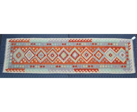 A vintage 20th century Anatolian Turkish Kilim carpet floor rug. Central red panel with repeating diamond form shapes with gr