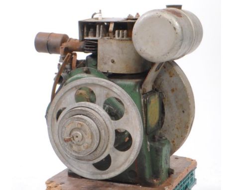 A vintage 20th century Petter stationary engine, in a green colourway with varying branded and safety plaques. Measures appro