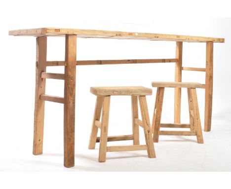 A vintage 20th century reclaimed elm console / hall table with two bar stools. Rectangular form with upright angled supports 
