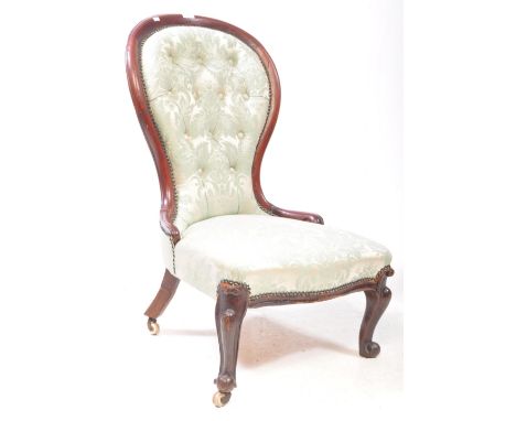 A Victorian 19th century mahogany spoon back nursing chair. Having button back rest with padded seat green floral upholstery 