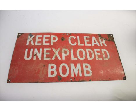 ENAMEL SIGN - UNEXPLODED BOMB a red enamel sign with white lettering, Keep Clear Unexploded Bomb. 68cms by 36cms