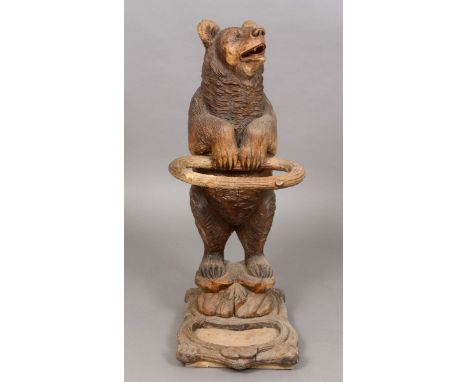 BLACK FOREST CARVED BEAR UMBRELLA/STICK STAND a late 19thc carved lindenwood stick stand in the form of a standing Bear, with