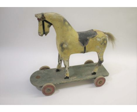 CHILDS PAINTED WOODEN PULL ALONG HORSE a vintage painted wooden model of Horse, with it's saddle and mounted on a wooden base