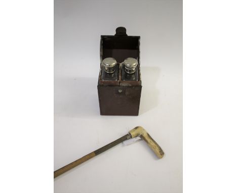 LEATHER CASED FLASKS a leather case containing 2 large glass flasks with silver plated lids, also with a horse measuring stic