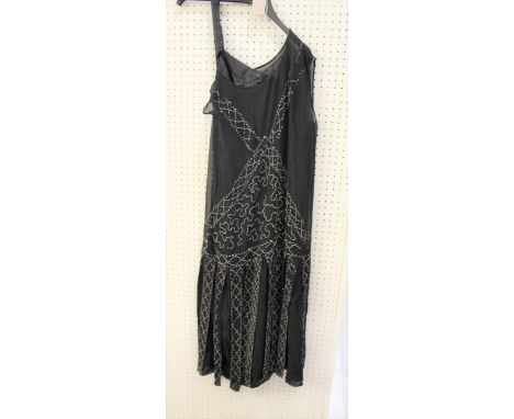 1920'S BLACK SILK COCKTAIL DRESS embellished with bead decoration, also with a length of black bead and sequin net circa 1920