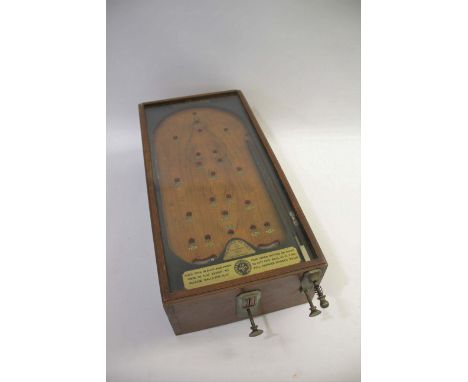 VINTAGE PINBALL GAME - 'THE ADVANCE PIN TABLE' a vintage pinball or bagatelle game The Advance Pin Table, in an oak case and 