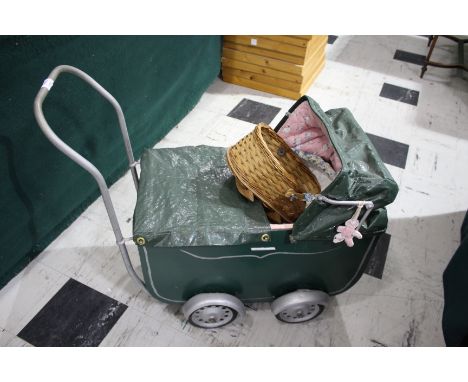 VINTAGE DOLLS PRAM - FRANCE a vintage wooden dolls pram painted in green, with metal wheels and with a canvas hood and cover.