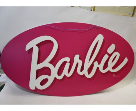 BARBIE SIGN a large oval cardboard sign, with white lettering on a pink background. Made in 2015, and marked for Mattel. 120c