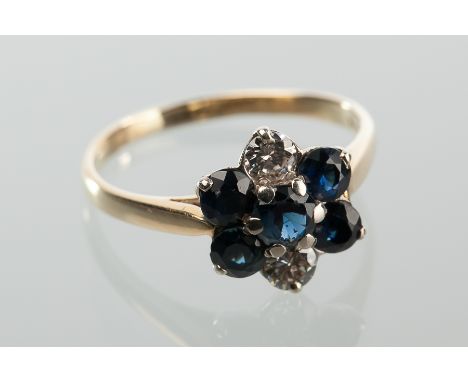 SAPPHIRE AND DIAMOND CLUSTER RING
set with five round sapphires and two brilliant cut diamonds, marked 18ct for eighteen cara