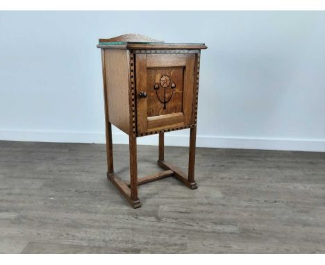 MATHEW POLLOCK FOR WYLIE AND LOCHHEAD, ARTS & CRAFTS OAK BESIDE CABINET, CIRCA 1900 enclosed by a floral marquetry panel door