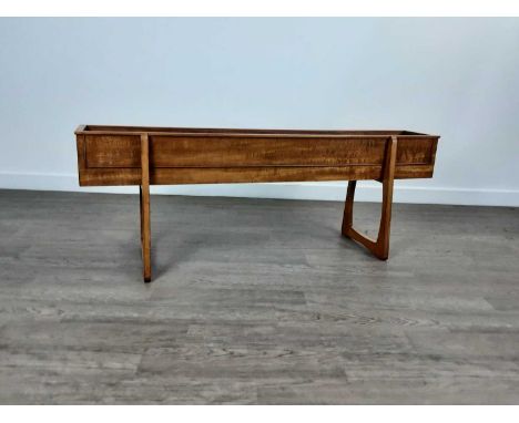 TEAK PLANTER, CIRCA 1960-69 the oblong trough with cockbeaded sides, on trestle supports45cm high, 123cm wide