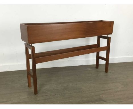 TEAK PLANTER, CIRCA 1960-69 the oblong trough over brass fittings to stretchered trestle supports66cm high, 107cm wide