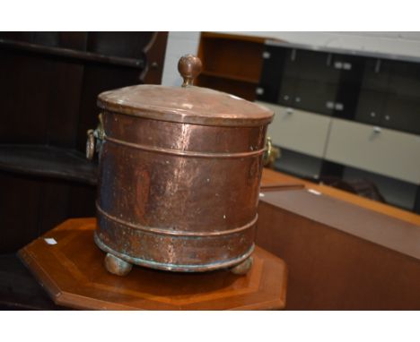 A traditional copper coal bucket having brass ring handles