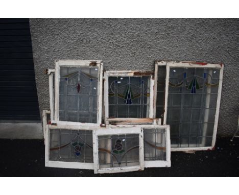 A selection of vintage windows in frame, with stained glass panels