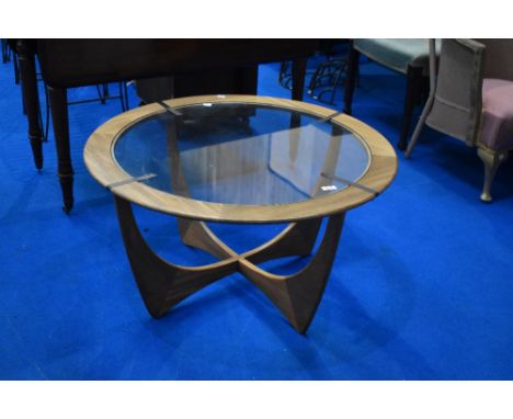 A vintage G plan coffee table having teak frame with glass centre, diameter approx. 84cm, labelled to underside