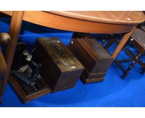 Two vintage sewing machines in cases