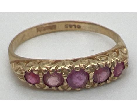 A vintage 9ct and ruby eternity style ring with a scroll design mount. Fully hallmarked inside band. Ring size NÂ½. 
