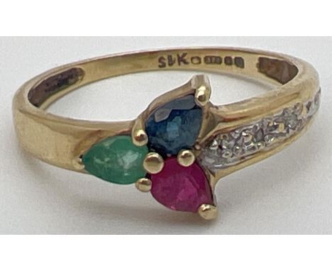 A 9ct yellow gold multi stone trinity ring with a pear cut emerald, sapphire &amp; ruby in a 3 point star design. With 3 smal