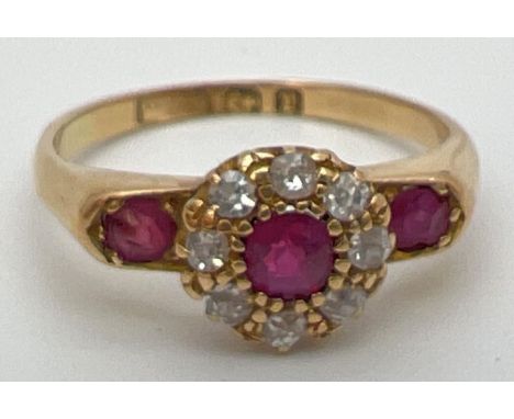 A vintage 18ct gold, ruby and diamond ring with wide shoulder design setting. Central .2ct ruby surrounded by 8 diamonds and 