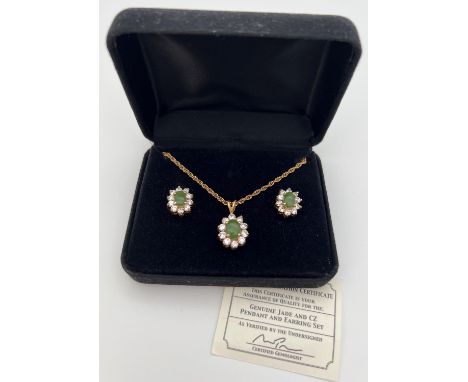 An 18ct gold plated pendant necklace and matching earrings set with Jade &amp; cubic Zirconias. In a flower shaped halo setti