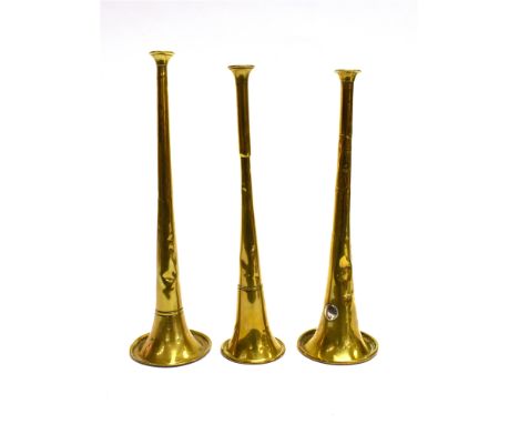 A BRASS HUNTNG HORN with circular plated disc 'Asford Maker to the Queen' and fox mask decoration, and two further brass hunt