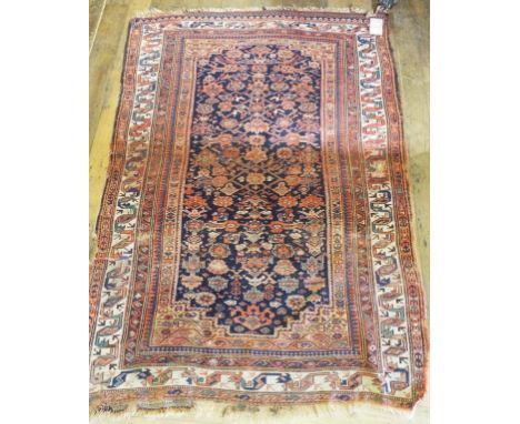 A Persian rug, decorated geometric motifs, on a blue ground, 207 x 150 cm