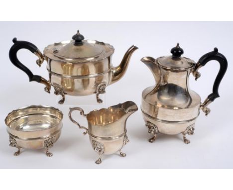 A silver four piece tea service, with lion mask feet, Edward Barnard & Sons Ltd, London 1926 & 27, approx. 47.7 ozt (all in) 