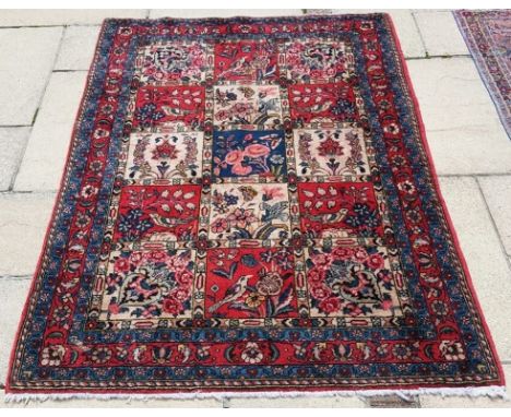 A Persian rug, decorated panels of birds and flowers, 157 x 106 cm