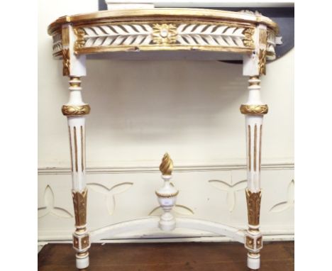 A gilt gesso three plate mirror, decorated flowers, swags and foliage, 101 cm wide, and a painted console table, 90 cm wide (