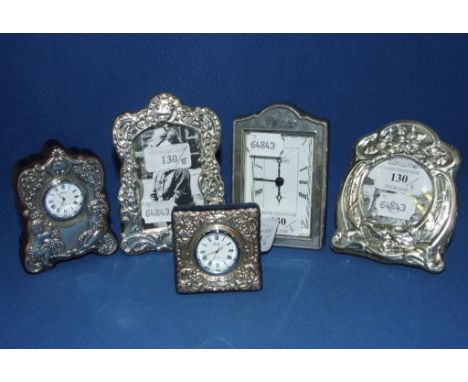 A silver mounted desk clock, Sheffield 2000, 6 cm high, two other clocks, and two silver mounted photograph frames (5)