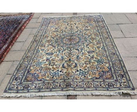 A Persian rug, decorated stylised floral motifs on a cream ground, 246 x 158 cm