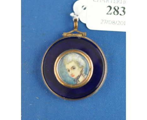 A portrait miniature of a lady, watercolour on ivory, 2 cm diameter, in a pendant mount with enamel decoration