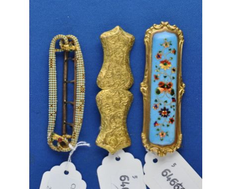 A gilt metal and enamel buckle, another similar, and another (3)