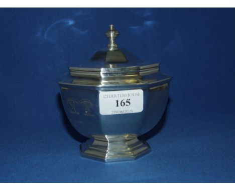 An octagonal silver tea caddy, crested, London 1924, approx. 12.1 ozt, 12 cm high
