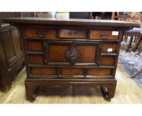 A Chinese cabinet, of small proportions, with three frieze drawers and a pair of panel doors, 78.5 cm wide