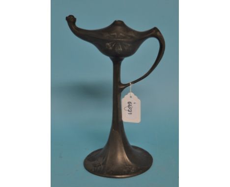 An Art Nouveau Kayserzinn pewter table oil lamp, with loop handle and raised foliate decoration, the base stamped 4439, 24 cm