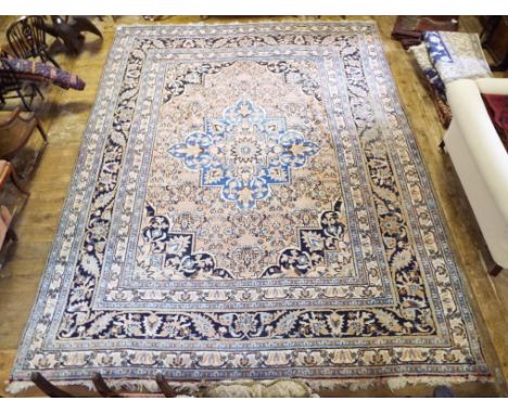 A Persian style carpet, decorated floral motifs, on a coral ground, within a multi border, 430 x 333 cm
