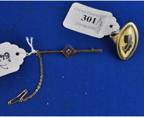 A yellow coloured metal ring, the navette centre with a silhouette portrait of a lady, and a 9ct gold bar brooch (2) 