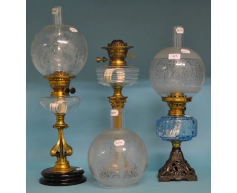 A Victorian oil lamp, with blue glass reservoir, and etched glass shade, 52 cm high, and two other oil lamps (3)