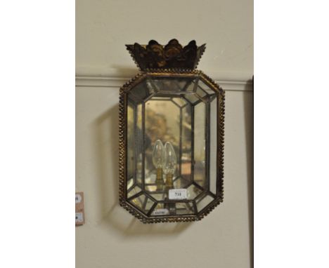 An octagonal single light wall lantern, fitted silvered mirror panels and brass finials, and its pair, 38 cm high (2)